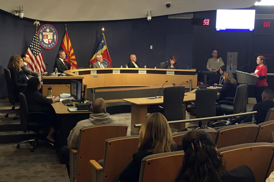 The Maricopa County Board of Supervisors listens to comments from Marie Thearle, right, a gun control supporter, during a meeting in Phoenix on Wednesday, Feb. 26, 2020. Arizona's most populous county on Wednesday joined a growing national movement in which areas are declaring themselves Second Amendment sanctuaries and proclaiming support for gun ownership rights. (AP Photo/Terry Tang)