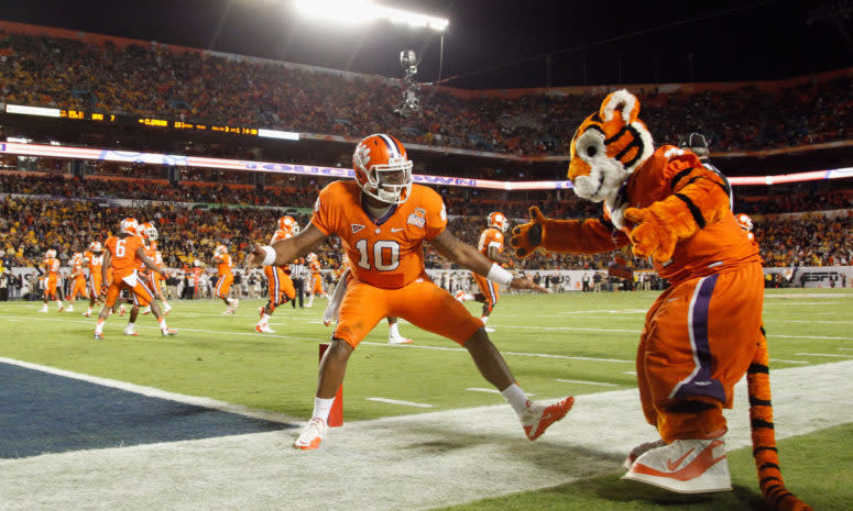 Tajh Boyd of the Clemson Tigers celebrates with the Clemson mascot after he threw a 27-yard touchdown pass to Sammy Watkins #2 in the first quarter.