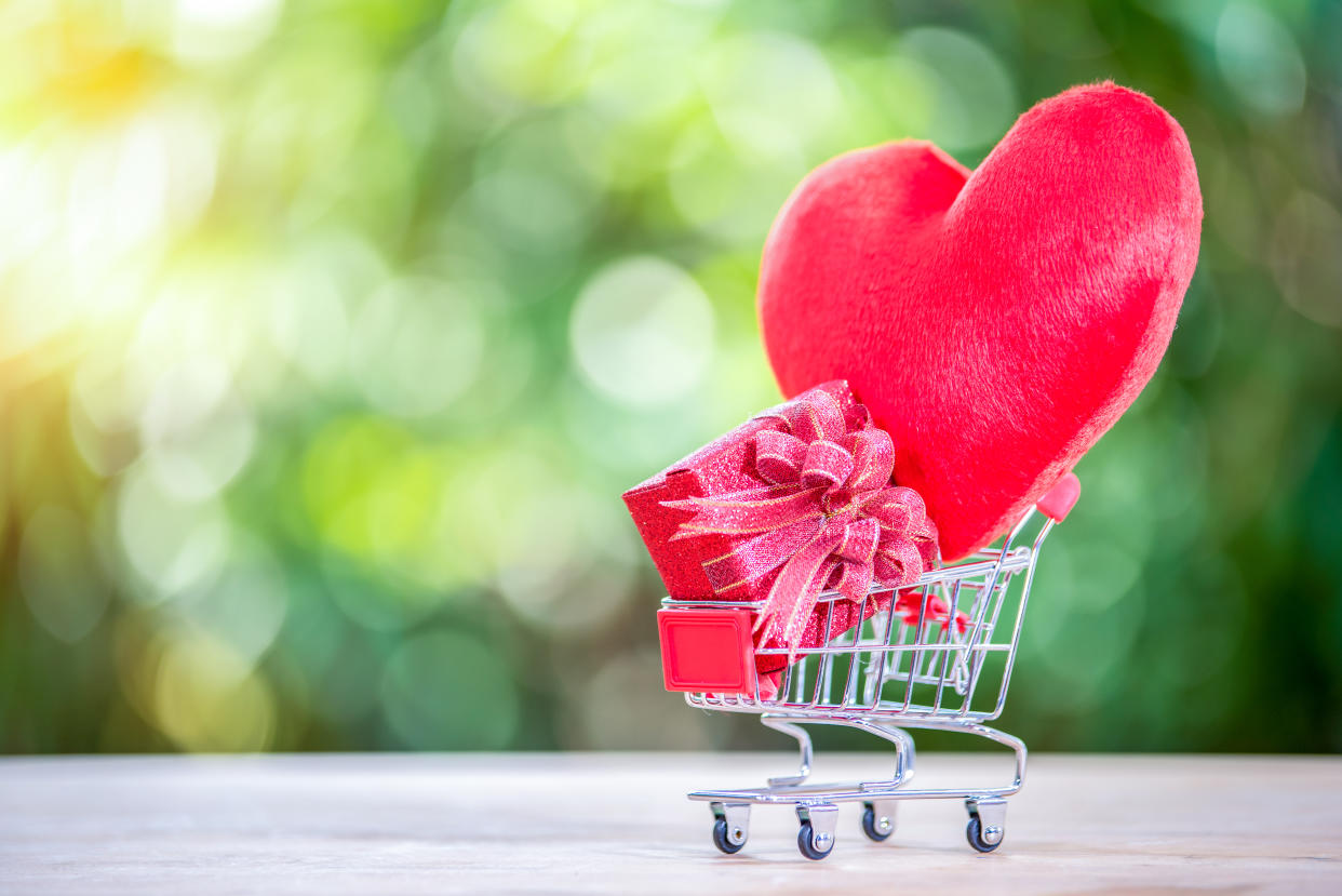 Red heart in the shopping cart.Online dating concept.