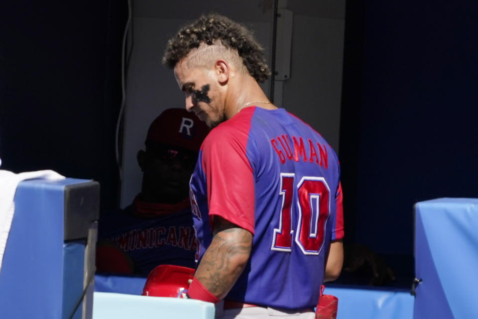 Dominican Republic's Jeison Guzman (10) walks in the dugout following a game against the United States at the 2020 Summer Olympics, Wednesday, Aug. 4, 2021, in Yokohama, Japan. (AP Photo/Sue Ogrocki)