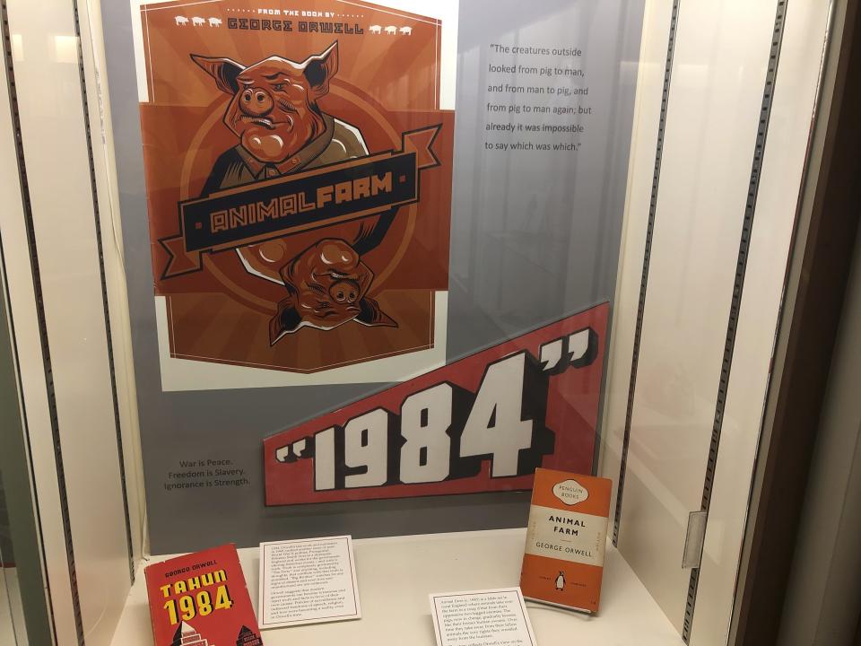 In this Oct. 21, 2019, photo, a poster promoting George Orwell's novels "Animal Farm" and "1984" is shown at an exhibit in Albuquerque, N.M. celebrating the author's legacy. The exhibit at the University of New Mexico is tackling the themes of the novelist's work from "1984" to "Animal Farm." "George Orwell: His Enduring Legacy," which runs to April 2020, features posters and material related to work challenging totalitarianism. (AP Photo/ Russell Contreras)