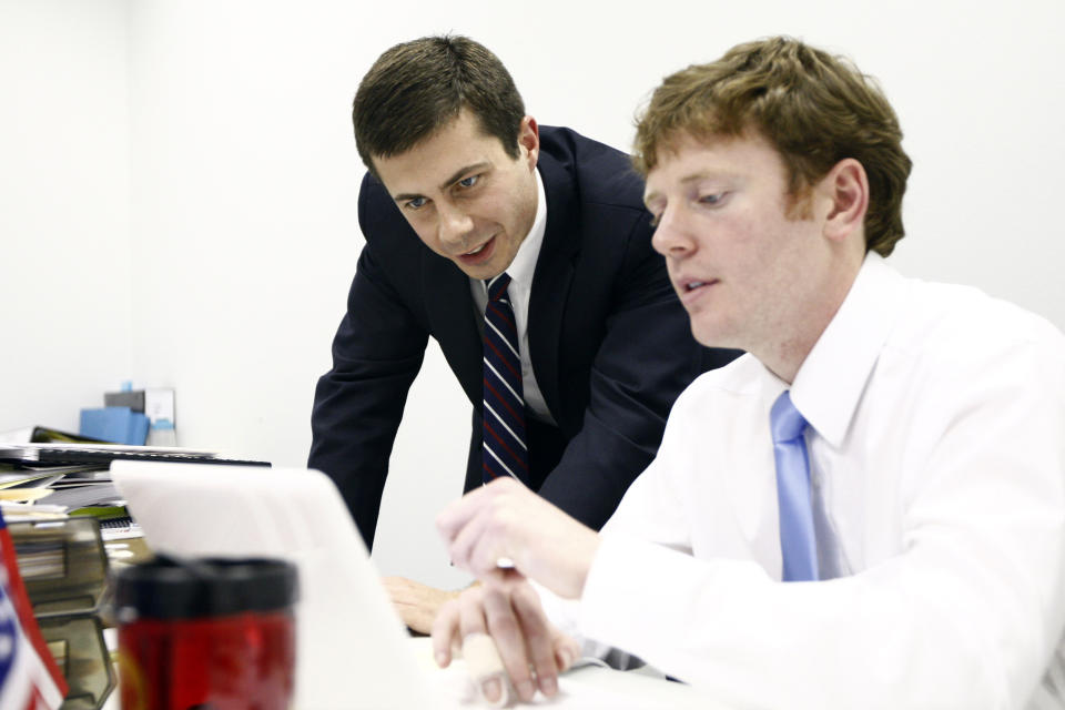 FILE - In this Nov. 8, 2011, file photo, Pete Buttigieg looks over return numbers with his campaign manager Mike Schmuhl in South Bend, Ind., (Marcus Parter,/South Bend Tribune via AP)