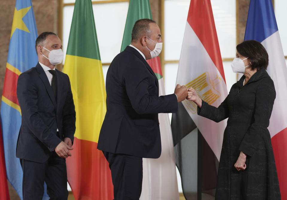 German Foreign Minister Heiko Maas, left, and Rosemary DiCarlo Under-Secretary for Political andPeacebuilding Affairs of the UNO, right, welcome Turkish Foreign minister Mevlut Cavusoglu for the 'Second Berlin Conference on Libya' at the foreign office in Berlin, Germany, Wednesday, June 23, 2021. (AP Photo/Michael Sohn, pool)