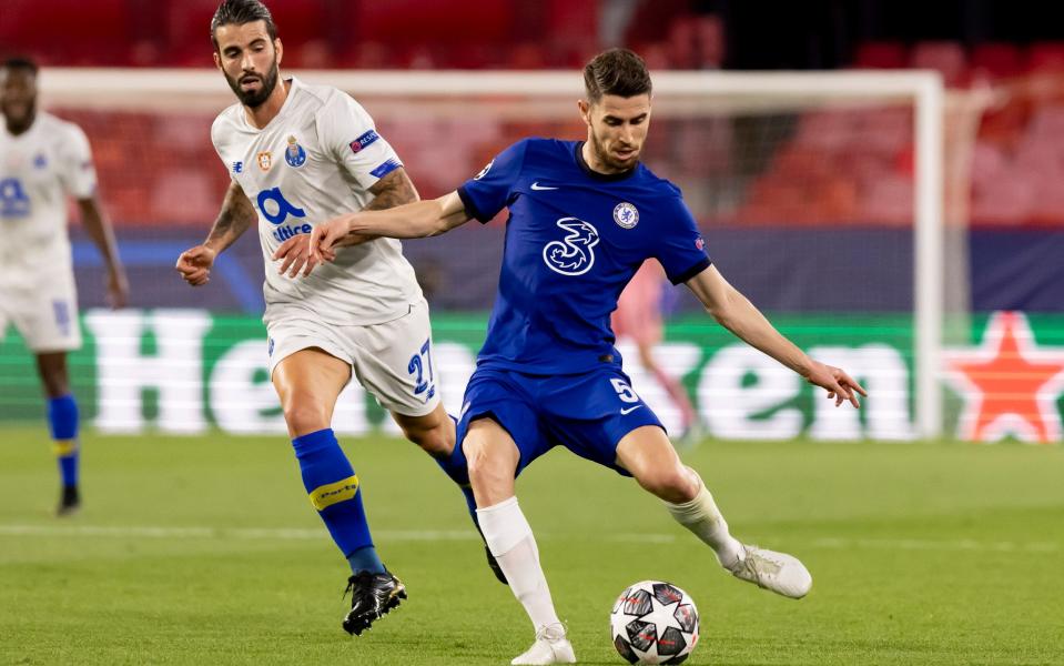 Sergio Oliveira of FC Porto and Jorginho of Chelsea FC battle for the ball during the UEFA Champions League Quarter Final Second Leg match between Chelsea FC and FC Porto at Estadio Ramon Sanchez Pizjuan on April 13, 2021 in Seville, Spain. Sporting stadiums around Spain remain under strict restrictions due to the Coronavirus Pandemic as Government social distancing laws prohibit fans inside venues resulting in games being played behind closed doors - Getty Images/DeFodi Images 