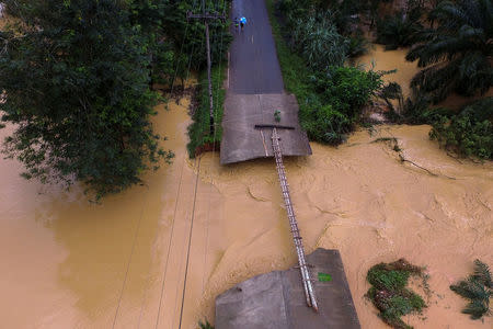 A bridge damaged by floods is pictured at Chai Buri District, Surat Thani province, southern Thailand, January 9, 2016. Picture taken January 9, 2016. Dailynews/ via REUTERS