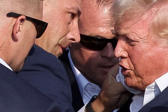 Secret Service observing Donald Trump's face after he's rushed off the stage in Butler, Pensilvania.
