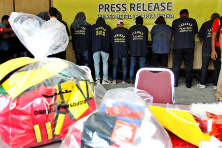 Some of the more than 140 men detained after a raid on what authorities described as a gay prostitution ring being run out of an entertainment venue are shown to the media at a police station in Jakarta, Indonesia May 22, 2017 in this photo taken by Antara Foto. Antara Foto/Reno Esnir via REUTERS