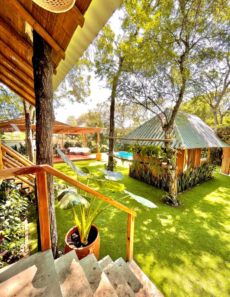 View from front stairs of outdoor structure and deck.