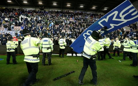 Policeman - FA poised for investigation after Sergio Aguero clashes with invading fan after Manchester City's Cup exit at Wigan - Credit: Action Images