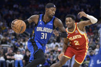 Orlando Magic guard Terrence Ross (31) drives to the basket while defended by Atlanta Hawks guard Trent Forrest (2) during the first half of an NBA basketball game Wednesday, Nov. 30, 2022, in Orlando, Fla. (AP Photo/Phelan M. Ebenhack)