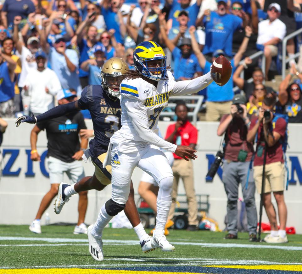 Delaware's Chandler Harvin celebrates his touchdown good for the eventual winning points ahead of Navy's Elias Larry in the third quarter of the Blue Hens' 14-7 win at Navy-Marine Corps Memorial Stadium in Annapolis, Md., Saturday, Sept. 3, 2022.