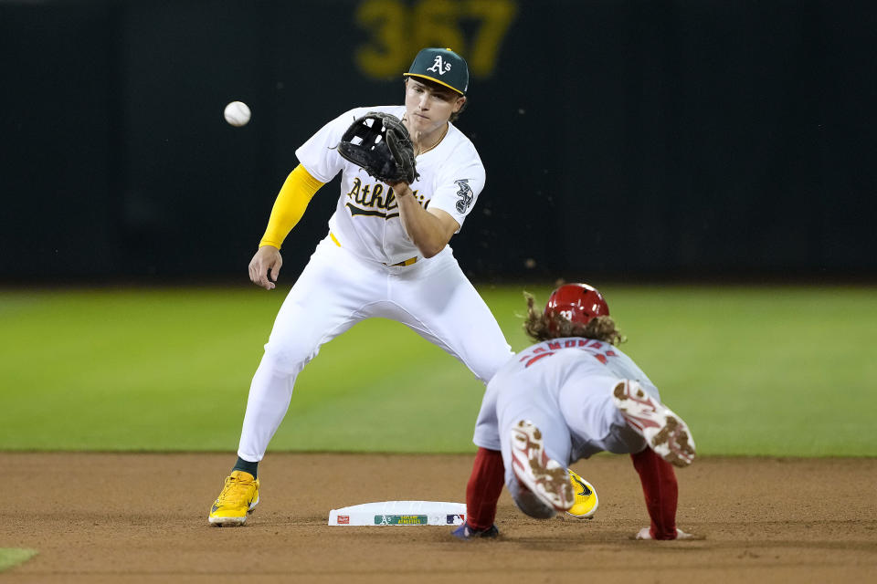 Oakland Athletics second base Zack Gelof, left, tags out St. Louis Cardinals' Brendan Donovan, right, attempting to steal second base during the seventh inning of a baseball game in Oakland, Calif., Tuesday, April 16, 2024. (AP Photo/Tony Avelar)