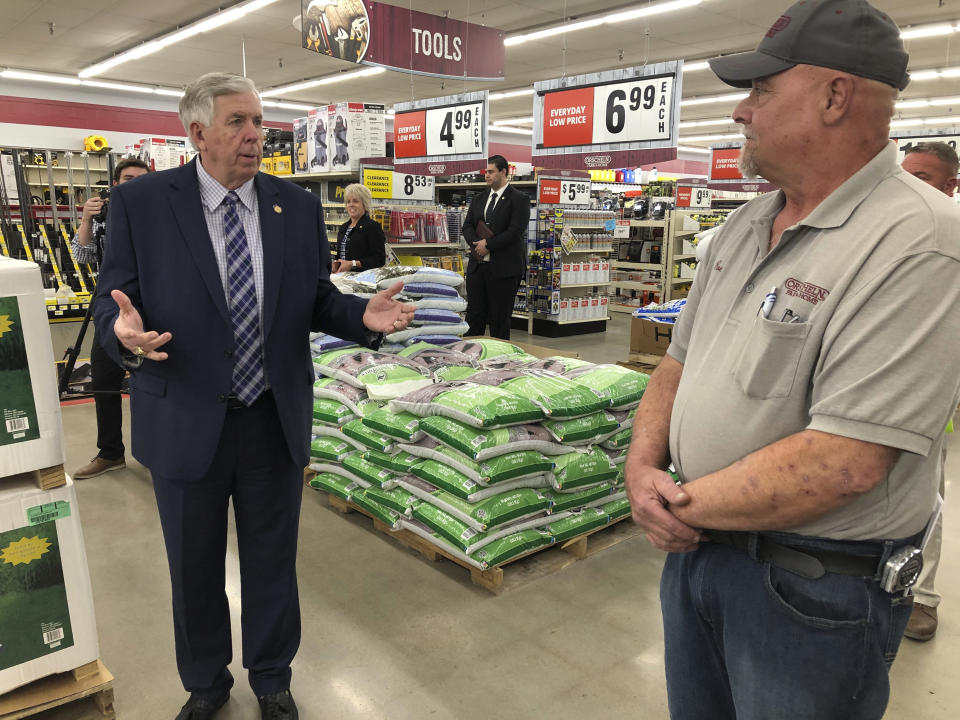 Gov. Mike Parson, left, talks with store manager Ron Schuman, right, during a tour of the Orscheln Farm & Home store on Thursday, May 7, 2020, in Jefferson City, Mo. Parson was visiting the store to promote the end of a stay-at-home order he had issued because of the coronavirus pandemic. The Republican governor discussed the demand for personal protective equipment among businesses and shoppers. “We always hear about overseas _ it’s cheaper to do it in China, it’s cheaper to do it in other countries," Parson says. “But one thing we’ve learned about this whole deal is we need to be dependent on ourselves. ... If we can do it here in Missouri, I think it would be well-worth the extra money." (AP Photo/David A. Lieb)