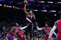 Portland Trail Blazers' CJ McCollum (3) goes up for a shot against Philadelphia 76ers' Paul Reed, from left, Shake Milton and Matisse Thybulle during the first half of an NBA basketball game, Monday, Nov. 1, 2021, in Philadelphia. (AP Photo/Matt Slocum)