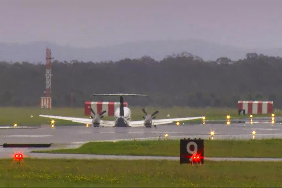 CORRECTS THE SOURCE - In this image taken from video, a light plane with three people aboard lands safely without landing gear at Newcastle Airport, Australia, Monday, May 13, 2024, after circling the airport for almost three hours to burn off fuel. The twin-turboprop Beechcraft Super King Air had just taken off from the airport north of Sydney for a 180-kilometer (112-mile) flight north to Port Macquarie when the pilot raised the alarm saying the landing gear had failed. (Channel 10 via AP)