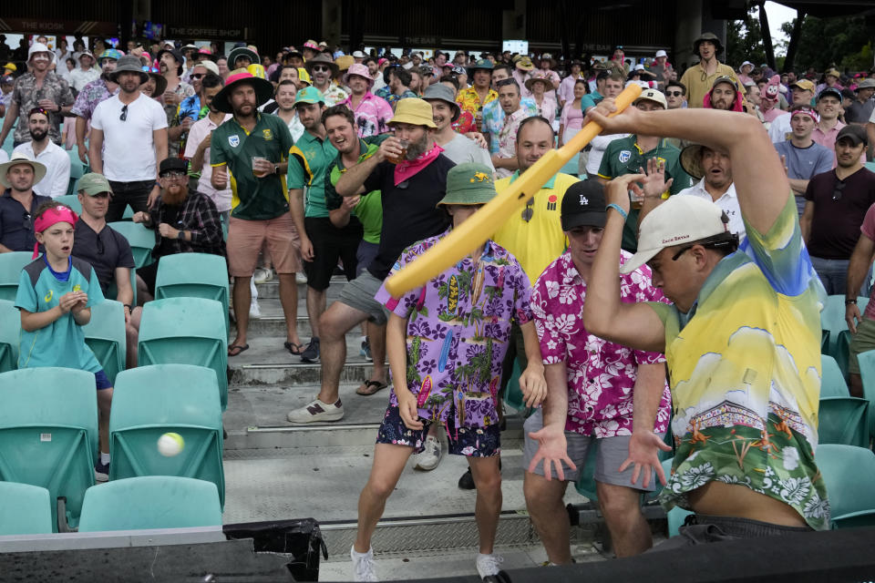 Young fans begin an impromptu game of cricket as play is suspended due to weather during the first day of their cricket test match between Australia and South Africa at the Sydney Cricket Ground in Sydney, Wednesday, Jan. 4, 2023. (AP Photo/Rick Rycroft)