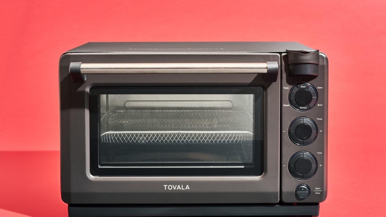 a small oven with a black knob