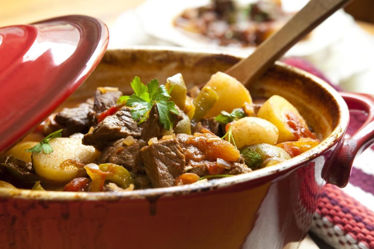 Traditional goulash or beef stew, in red crock pot, ready to serve