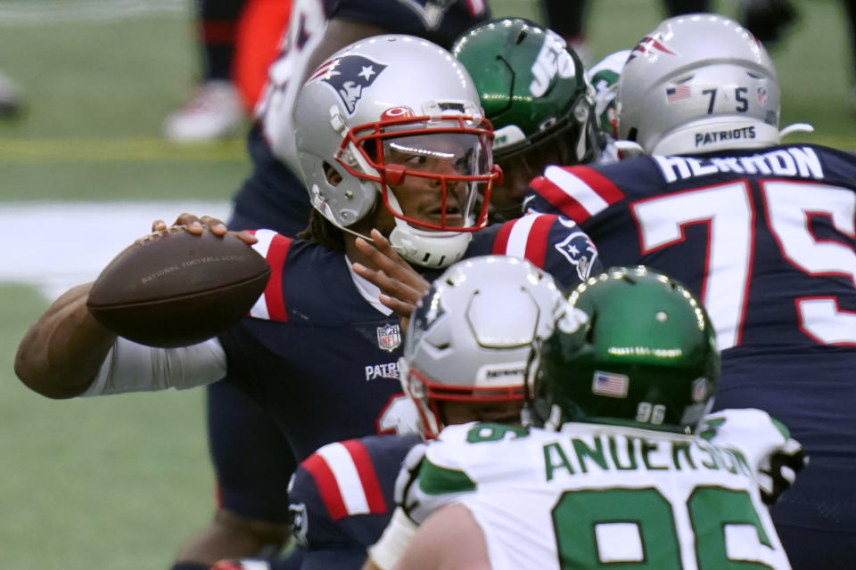 New England Patriots quarterback Cam Newton passes under pressure from New York Jets defensive end Henry Anderson in the first half of an NFL football game, Sunday, Jan. 3, 2021, in Foxborough, Mass. (AP Photo/Charles Krupa)