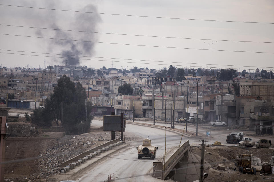 Kurdish-led Syrian Democratic Forces Humvee patrols in Hassakeh, northeast Syria, Monday, Jan. 24, 2022.Clashes between U.S.-backed Syrian Kurdish fighters and militants continued for a fourth day Sunday near the prison in northeastern Syria that houses thousands of members of IS, the Kurdish force said. (AP Photo/Baderkhan Ahmad)