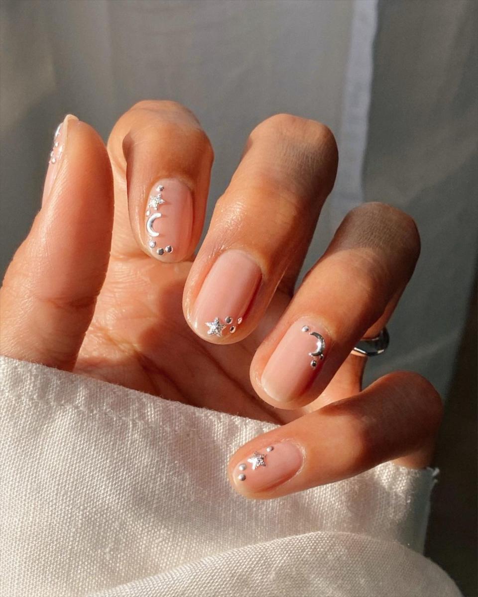 A sprinkling of silver stars adds a totally dreamy vibe to you manicure in seconds. Skip the base color and add a smattering of <a href="https://cna.st/affiliate-link/29WcPCBE59v2c5FrD6xkQiJ62XKqG2wsNz2m1nNxdnMzRL7eKzCjdTmJzoHQmQTrCuM3gAq6ERCSHD4yc8eKRXJu4tJCmQcbrUaYZMY?cid=5c659e233522902e4a03fbd8" rel="nofollow noopener" target="_blank" data-ylk="slk:Cirque Color's Celestial Charms;elm:context_link;itc:0;sec:content-canvas" class="link ">Cirque Color's Celestial Charms</a> for nails straight out of a fairy tale.