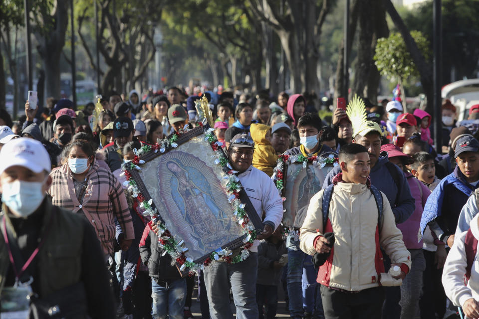 Devotees of the Virgin of Guadalupe walk to the Basilica to give thanks or worship a day before her national celebration in Mexico City, on Sunday, Dec. 11, 2022. (AP Photo/Ginnette Riquelme)