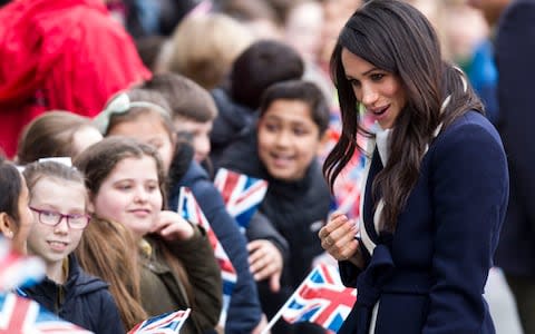 Meghan Markle chats to youngsters - Credit: Heathcliff O'Malley for The Telegraph 