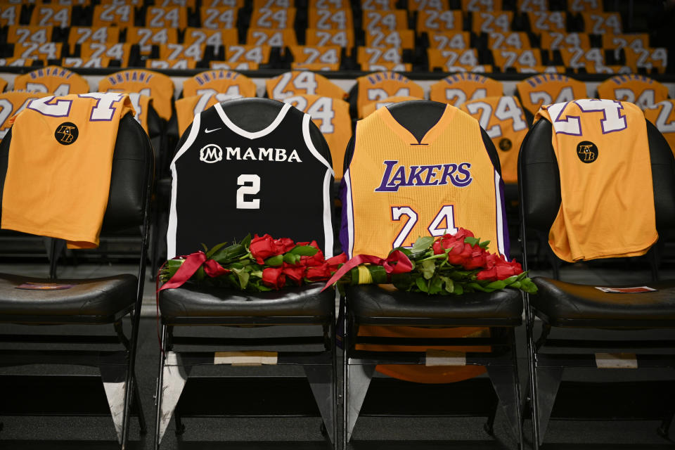FILE - In this Jan. 31, 2020, file photo, the jerseys of late Los Angeles Laker Kobe Bryant, right, and his daughter Gianna are draped on the seats the two last sat on at Staples Center, prior to the Lakers' NBA basketball game against the Portland Trail Blazers in Los Angeles. A person with knowledge of the details says a public memorial service for Bryant, his daughter and seven others killed in a helicopter crash is planned for Feb. 24 at Staples Center. The Los Angeles arena is where Bryant starred for the Lakers for most of his two-decade career. The date corresponds with the jersey numbers he and 13-year-old daughter Gianna wore, 24 for him and 2 for her. (AP Photo/Kelvin Kuo, File)