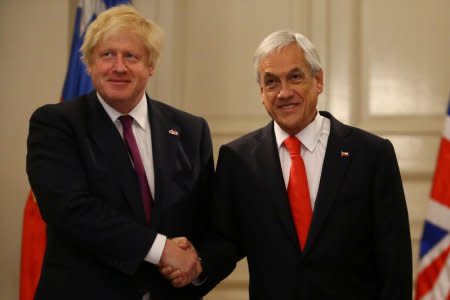 Chile's President Sebastian Pinera and Britain's Foreign Minister Boris Johnson shake hands in Santiago, Chile, May 23, 2018. REUTERS/Ivan Alvarado