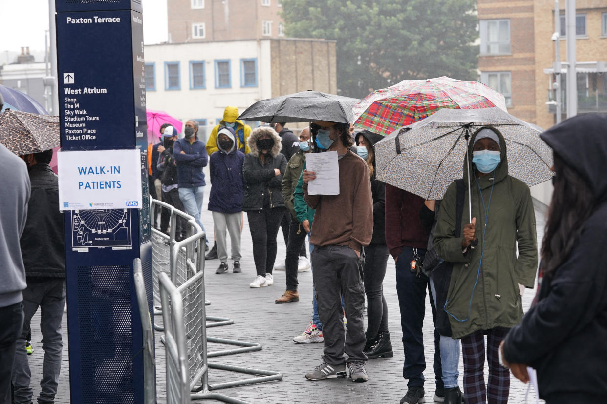 People queue at an NHS Vaccination Clinic at Tottenham Hotspur's stadium in north London. The NHS is braced for high demand as anyone in England over the age of 18 can now book a Covid-19 vaccination jab. Picture date: Sunday June 20, 2021.