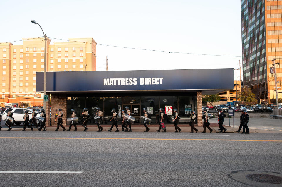 Riot police leave the scene of the protest in Clayton, a St. Louis suburb. (Photo: Joseph Rushmore for HuffPost)