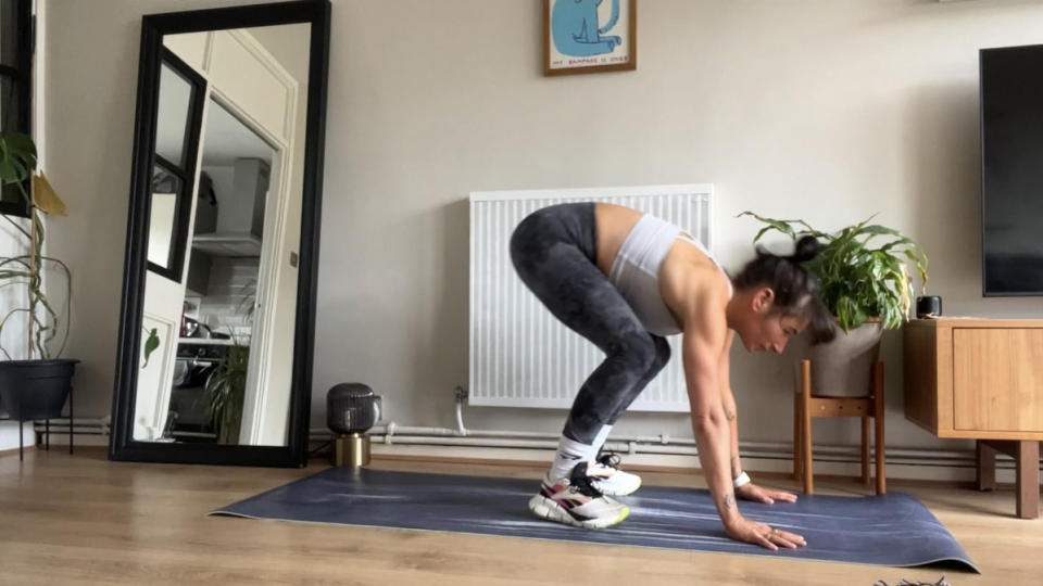 Writer Sam jumping forward from a burpee on yoga mat during home workout