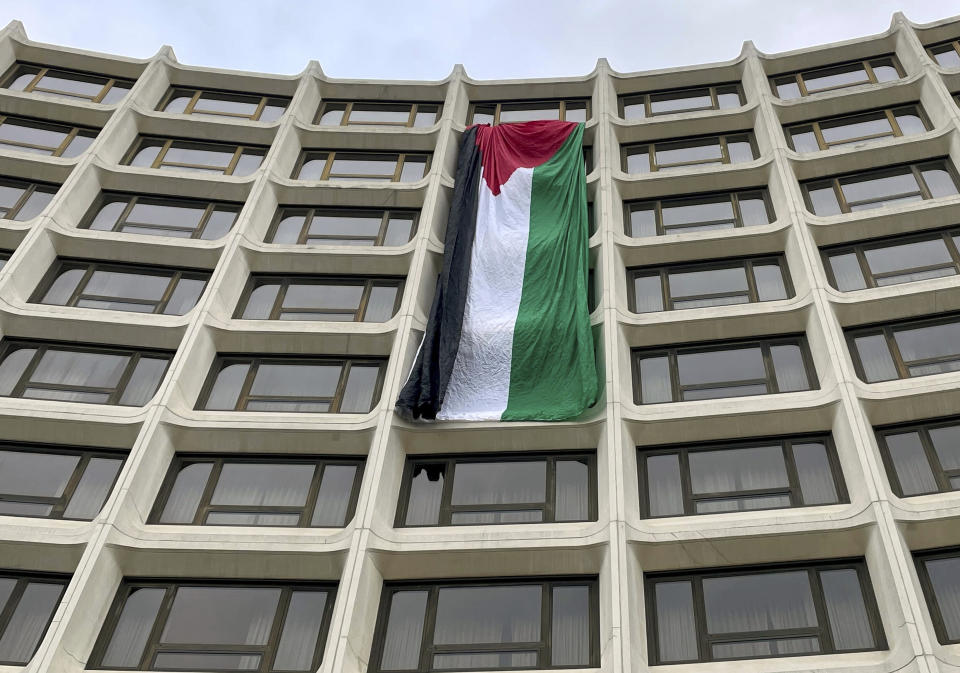 A Palestinian flag hangs on the side of the Washington Hilton as demonstrators protest the Israel-Hamas war before the start of the White House Correspondents' Association Dinner, Saturday, April 27, 2024, in Washington. (AP Photo/Pablo Martinez Monsivais)