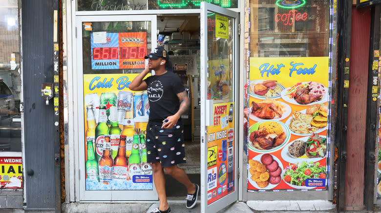 man walking out of bodega