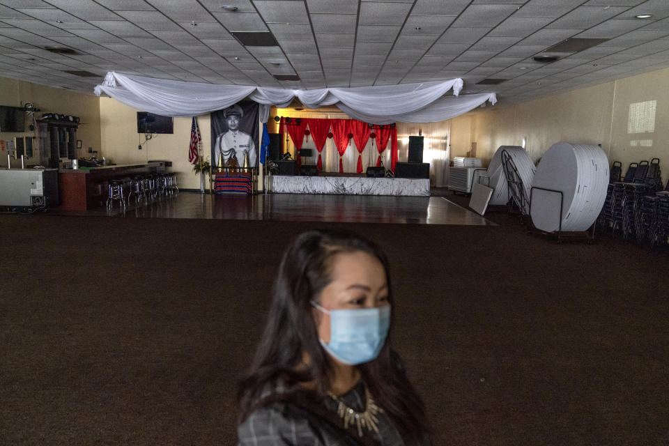 Businesswoman and city councilor, Maiyoua Thao, 43, stands in the virus-shuttered banquet hall that serves the area's 5,000 Hmong immigrants, Aug. 19, 2020, in Appleton, Wis. Thao, a Hmong refugee from Laos, was initially drawn to the President Donald Trump mythology. She read his books and stayed in his hotel. But his administration has irked her by slashing the admission of refugees this year. She refuses to weigh in on national politics, saying that doing so could alienate the residents she serves. "I just want to see us Americans continue to be powerful and to be the heroes to the world." (AP Photo/David Goldman)