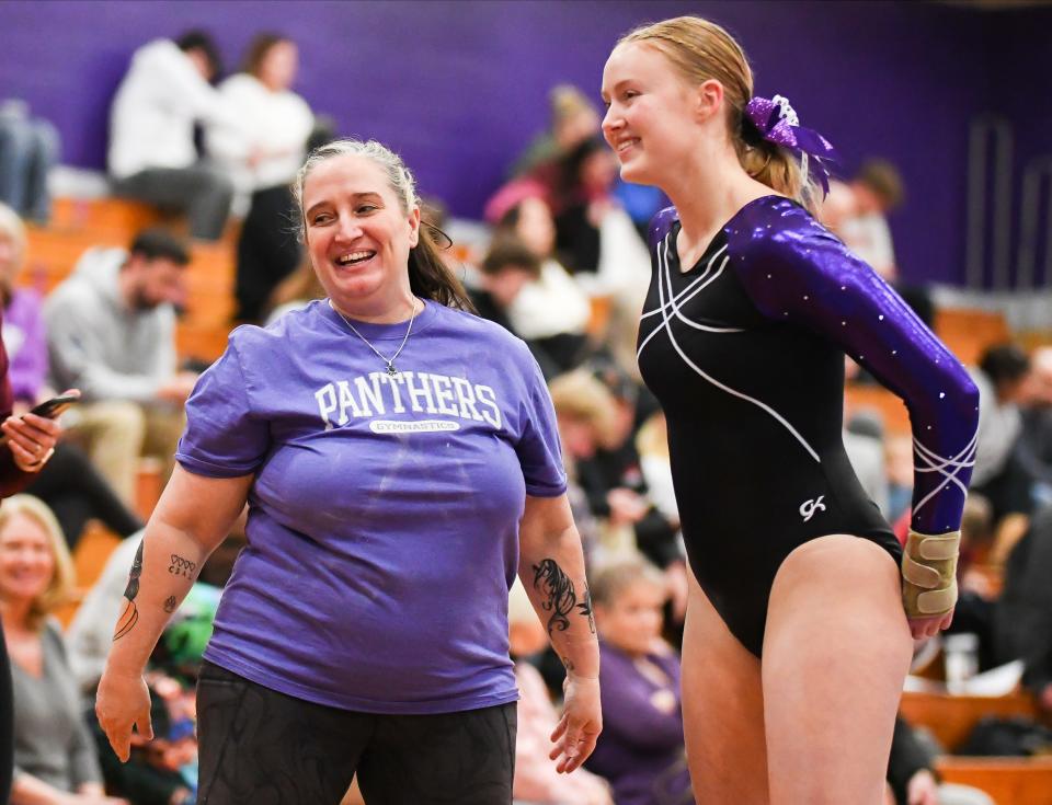 Bloomington South head coach Michelle Stroud and Chloe Gautier smile during the gymnastics meet against Bloomington North and Edgewood at South on Monday, Jan. 8, 2024.