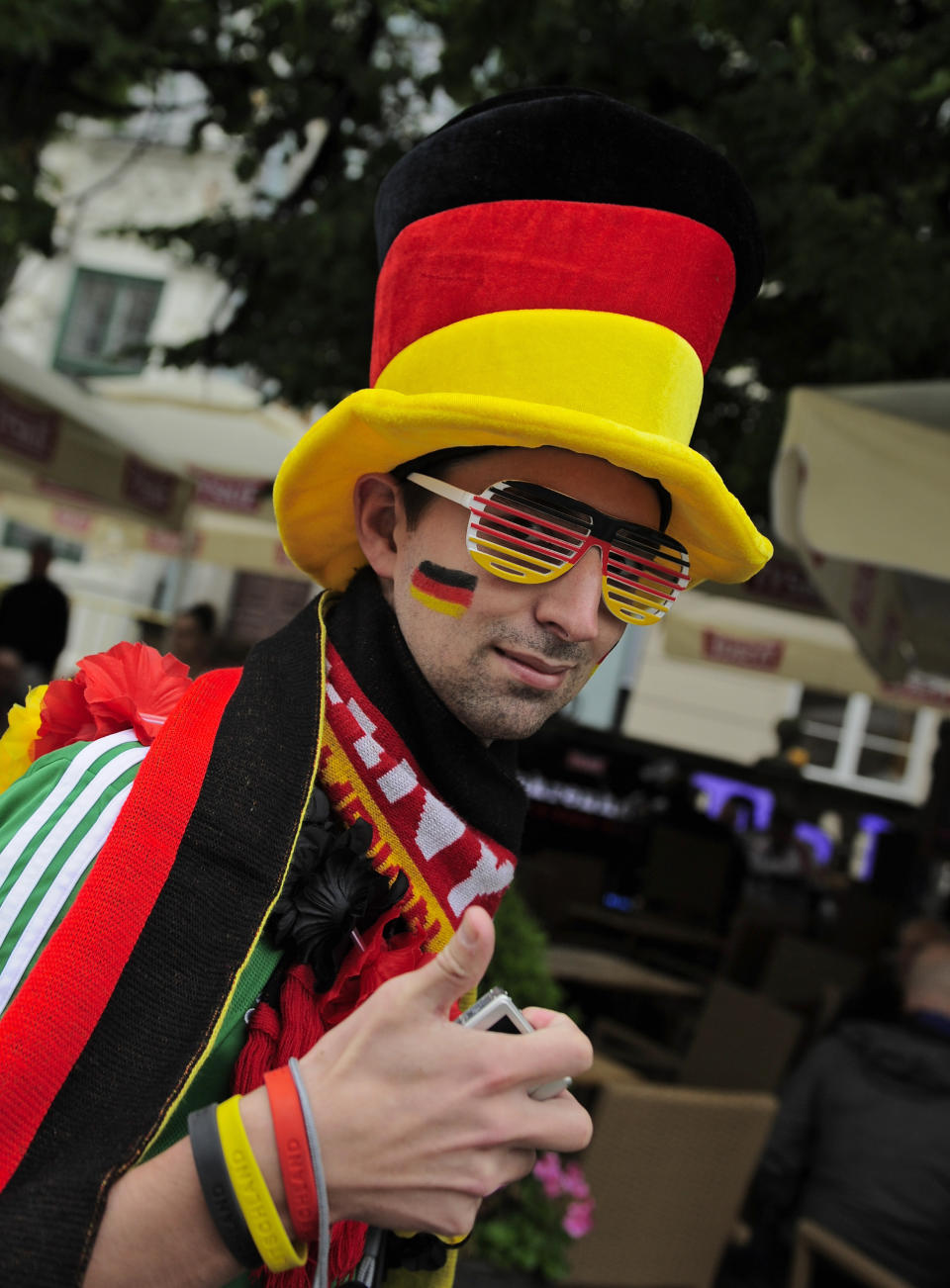 A German fan cheers while he walks through the old city before the Euro 2012 soccer championship quarterfinal match between Germany and Greece in Gdansk, Poland, Friday, June 22, 2012. (AP Photo/Alvaro Barrientos)