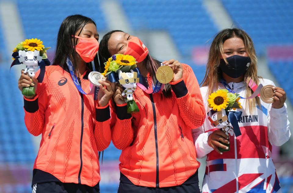 Gold medalist Yosozumi Sakura C of Japan, silver medalist Hiraki Kokona L of Japan and bronze medalist Sky Brown of Great Britain pose for photo at the awarding ceremony of women's park final of skateboarding at the Tokyo 2020 Olympic Games in Tokyo, Japan, Aug. 4, 2021. (Photo by Li Ga/Xinhua via Getty Images)