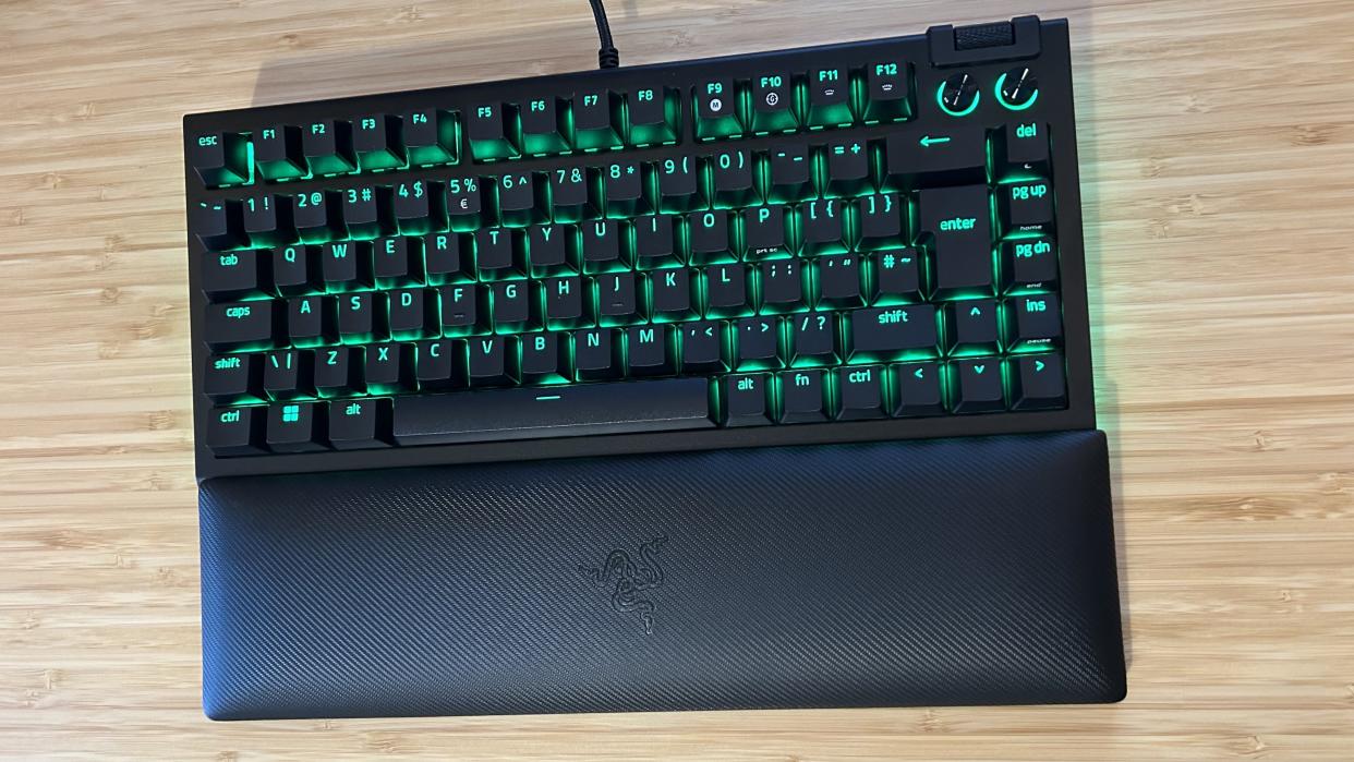  Razer BlackWidow V4 75% keyboard on a wooden desk top. 