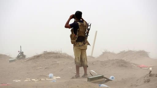 A pro-government Yemeni soldier looks through binoculars on June 7, 2018, near the city of Al Jah in Hodeida province, 50 kilometres (30 miles) from the port city of Hodeida