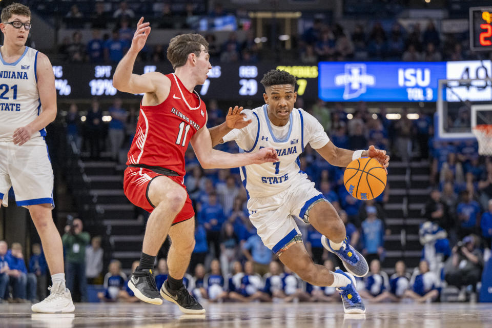 Indiana State guard Julian Larry (1) drives against Illinois State guard Johnny Kinziger (11) during the second half of an NCAA college basketball game Tuesday, Feb. 13, 2024, in Terre Haute, Ind. (AP Photo/Doug McSchooler)