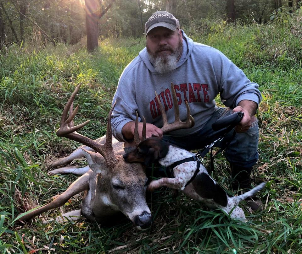 Brian Yoder, of Walhonding, poses with his tracking dog, Jack, and one of the deer the two of them recovered.