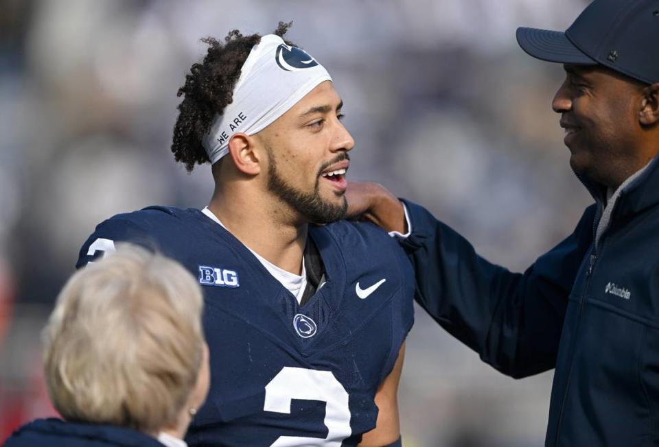 Penn State safety Keaton Ellis greets his parents as part of the Senior Day celebration before the game against Rutgers on Saturday, Nov. 18, 2023.