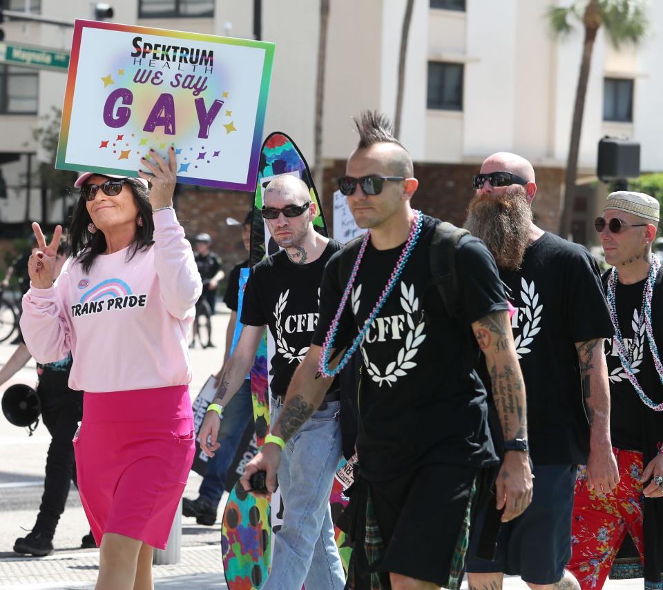 Alexandra Steele (71) from Palm Bay holds a sign, “ We Say Gay”, during the National March to Protect Trans Youth on Saturday, October 7th, 2023 in Orlando.