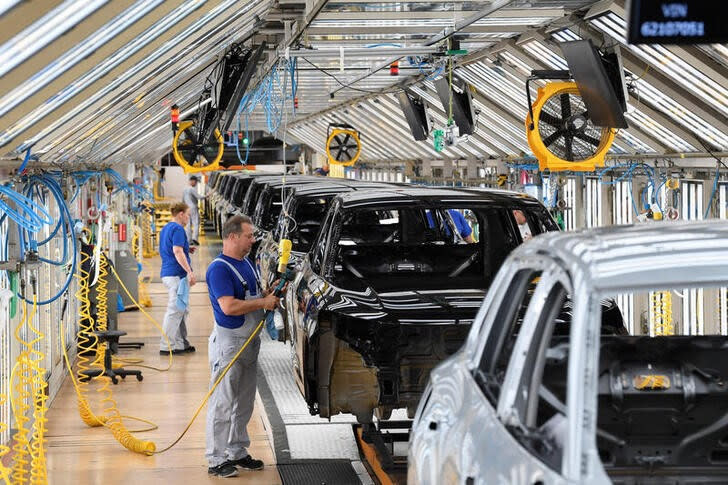 Volkswagen employee works on a production line for the Golf VIII and Tiguan cars at the VW headquarters in Wolfsburg, Germany May 23, 2024. REUTERS/Fabian Bimmer