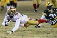 Jan 5, 2014; Green Bay, WI, USA; San Francisco 49ers wide receiver Michael Crabtree (15) makes a diving catch against the Green Bay Packers during the second half of the 2013 NFC wild card playoff football game at Lambeau Field. San Francisco 49ers defeat the Green Bay Packers 23-20. Mandatory Credit: Mike DiNovo-USA TODAY Sports