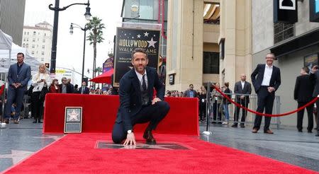 Actor Ryan Reynolds touches his star after it was unveiled on the Hollywood Walk of Fame in Hollywood, California U.S., December 15, 2016. REUTERS/Mario Anzuoni