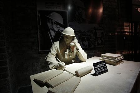 A model and a photograph of John Rabe, sometimes call "China's Schindler", are seen in a museum, during a reporting trip in Nanjing, Jiangsu province February 19, 2014. REUTERS/Aly Song