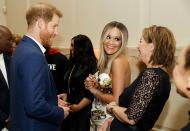 New dad Prince Harry charms Rita Ora and her mother, Vera Sahatciu, at the 2019 Sentebale Audi Concert at Hampton Court Palace on Tuesday.