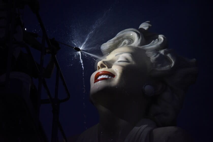 The sculpture "Forever Marilyn" is sprayed in the middle of the night during the sculpture's installation.